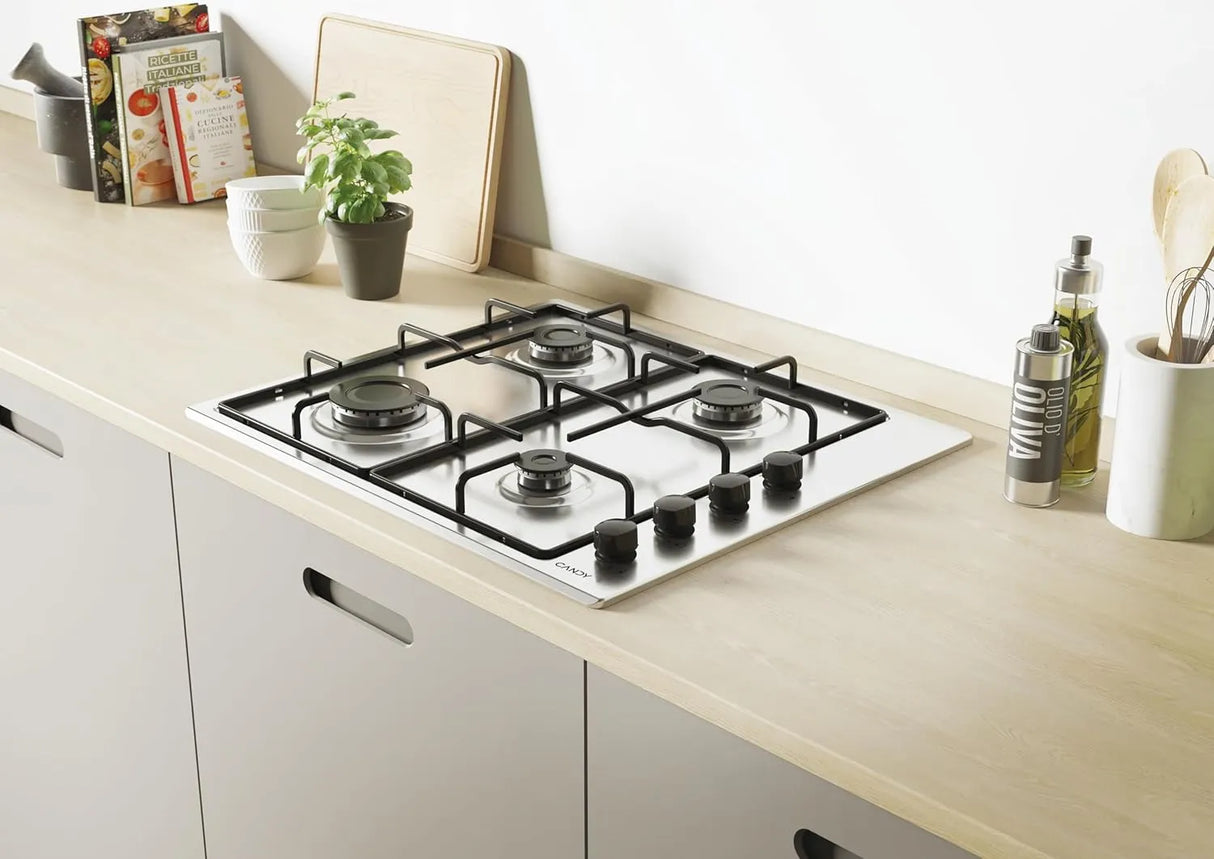 Piano cottura a gas Candy CHW6LBX da incasso, 4 fuochi in acciaio inox con griglie in metallo e valvola di sicurezza, design moderno e compatto.