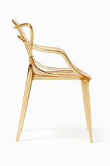 Sedia Curve in polipropilene trasparente color oro con design moderno e linee intrecciate