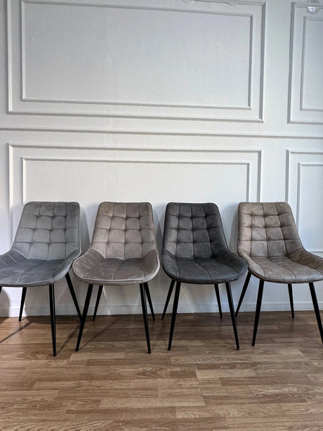 Sedia Gilda moderna imbottita con gambe nere in tessuto vintage o velluto, disponibile in quattro colori.