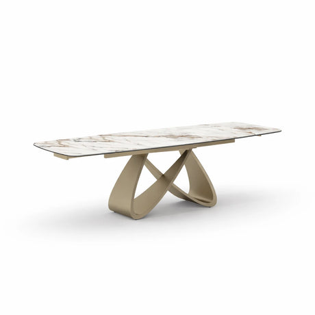 Tavolo Wings allungabile in ceramica effetto marmo calacatta con base intrecciata color champagne