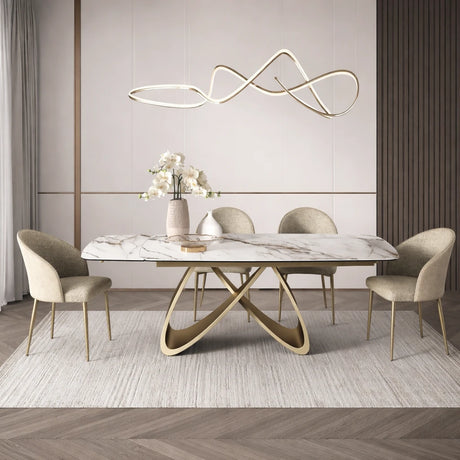 Tavolo Wings allungabile in ceramica effetto marmo calacatta con base intrecciata color champagne